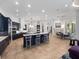 Open-concept kitchen with dark blue cabinetry, double islands, and seamless flow to the breakfast and living areas at 1707 Stetson Ct, Longwood, FL 32779