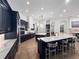 Large kitchen with dark cabinetry, double islands, marble counters, and open layout to the dining and living spaces at 1707 Stetson Ct, Longwood, FL 32779