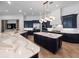 A gourmet kitchen with dark blue cabinetry, stainless appliances, an island, and marble countertops at 1707 Stetson Ct, Longwood, FL 32779