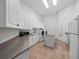 Bright laundry room with white cabinetry, granite countertops, and modern washer and dryer at 1707 Stetson Ct, Longwood, FL 32779
