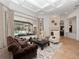 Inviting living room featuring a fireplace, a large window with a pool view, and elegant furniture at 1707 Stetson Ct, Longwood, FL 32779