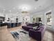 Open concept living area showcasing a purple sectional, breakfast bar, and modern lighting fixtures at 1707 Stetson Ct, Longwood, FL 32779