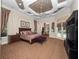Comfortable main bedroom suite featuring a tray ceiling, carpeting, and outdoor access at 1707 Stetson Ct, Longwood, FL 32779