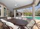 Covered outdoor dining area offers a spacious table, comfortable seating, and a view of the pool at 1707 Stetson Ct, Longwood, FL 32779