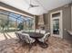Outdoor patio with a full dining table under a screened-in ceiling at 1707 Stetson Ct, Longwood, FL 32779