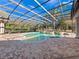 Screened-in pool area with water features and extensive brick patio at 1707 Stetson Ct, Longwood, FL 32779