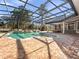 An aerial shot of the enclosed pool area, adjacent to the outdoor kitchen and dining space at 1707 Stetson Ct, Longwood, FL 32779