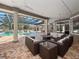 Outdoor pool area with multiple seating areas, and a screened-in ceiling at 1707 Stetson Ct, Longwood, FL 32779