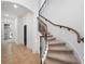 Elegant staircase with wrought iron railings and carpeted steps leading to the upper level at 1707 Stetson Ct, Longwood, FL 32779