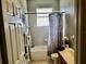 Well-lit bathroom with a combined shower and bathtub, tiled walls, and vanity with good counter space at 1838 Palmerston Cir, Ocoee, FL 34761