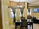 Inviting dining area with a marble table, a chandelier, and natural light from the beautiful decorated windows at 1838 Palmerston Cir, Ocoee, FL 34761