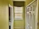 Hallway with window, blinds, decorative top, and closet with paneled doors at 1838 Palmerston Cir, Ocoee, FL 34761