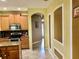 Open-concept kitchen with stainless steel appliances leads into hallway with archways and natural light at 1838 Palmerston Cir, Ocoee, FL 34761