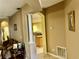 View of living room with decorative columns and doorway leads into open kitchen at 1838 Palmerston Cir, Ocoee, FL 34761