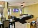 Living room featuring tile flooring, an entertainment center, and large windows at 1838 Palmerston Cir, Ocoee, FL 34761