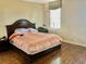 Comfortable main bedroom featuring laminate wood floors, a large bed, and good natural light at 1838 Palmerston Cir, Ocoee, FL 34761