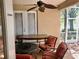 Relaxing screened-in porch with a ceiling fan, patio furniture, and outdoor dining set at 1838 Palmerston Cir, Ocoee, FL 34761