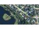 Aerial view of a neighborhood showing the home's location near a pond with a golf course at 1873 Poinciana Rd, Winter Park, FL 32792