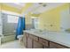 Spacious full bathroom features a long vanity, bathtub with shower, and natural light at 1873 Poinciana Rd, Winter Park, FL 32792