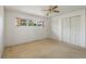 Bright bedroom features neutral carpet, a ceiling fan, one window, and closet storage at 1873 Poinciana Rd, Winter Park, FL 32792