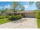 Charming single-story home featuring a lush front yard and a spacious driveway leading to an attached garage at 1873 Poinciana Rd, Winter Park, FL 32792
