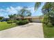 Charming single-story home featuring a well-manicured lawn and a spacious driveway leading to a two-car garage at 1873 Poinciana Rd, Winter Park, FL 32792
