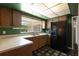 Kitchen featuring wood cabinets, solid countertops, and a view of the backyard through the window at 1873 Poinciana Rd, Winter Park, FL 32792