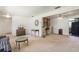 Spacious living room with a view of the kitchen, decorated with vintage furniture and unique art pieces at 1873 Poinciana Rd, Winter Park, FL 32792
