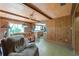 Comfortable living room showcases a ceiling fan, wooden paneling, and view into the kitchen at 1873 Poinciana Rd, Winter Park, FL 32792