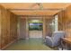 Living room area with wood paneling, built-in shelving, a ceiling fan, and comfortable seating at 1873 Poinciana Rd, Winter Park, FL 32792