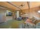 Cozy living room with wood paneling, ceiling fan, comfortable seating, and built-in shelving at 1873 Poinciana Rd, Winter Park, FL 32792