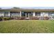 Backyard with a well-maintained lawn and mature shrubbery at 205 Hill St # 205, Casselberry, FL 32707