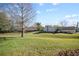 Expansive backyard with lush green grass and mature trees, perfect for outdoor activities and relaxation at 205 Hill St # 205, Casselberry, FL 32707