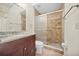 Bathroom featuring a glass-enclosed shower with tile surround, toilet, and granite-topped vanity at 205 Hill St # 205, Casselberry, FL 32707