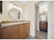 Bathroom with a vanity featuring granite countertops and dual sinks adjacent to another full bathroom at 205 Hill St # 205, Casselberry, FL 32707