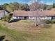 Ranch style home with a well-manicured lawn, mature tree, and a covered porch at 205 Hill St # 205, Casselberry, FL 32707