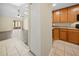 View of the kitchen, living room and enclosed patio, with tile flooring and neutral walls at 205 Hill St # 205, Casselberry, FL 32707