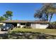 Charming single-story home featuring a well-maintained front yard and a car in the driveway at 209 Whippoorwill Dr, Altamonte Springs, FL 32701