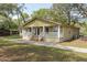 Rear of the house showing the porch with white railings and a concrete foundation at 2204 Votaw Rd, Apopka, FL 32703