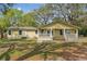 A well-maintained single-story home showcasing a rear deck and a spacious backyard at 2204 Votaw Rd, Apopka, FL 32703
