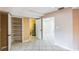 Spacious basement area with tile flooring, storage shelves, and access to the laundry room at 2204 Votaw Rd, Apopka, FL 32703