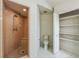 Updated bathroom with walk-in shower and storage shelving at 2204 Votaw Rd, Apopka, FL 32703
