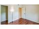 Bright bedroom featuring hardwood floors, neutral walls, and access to an ensuite bathroom at 2204 Votaw Rd, Apopka, FL 32703