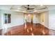 Large bedroom with hardwood floors, tray ceiling, fan, and walk-in closet at 2204 Votaw Rd, Apopka, FL 32703