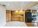 Galley kitchen with light wood cabinets and black appliances at 2204 Votaw Rd, Apopka, FL 32703