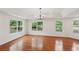 Bright living room featuring hardwood floors, a tray ceiling, and large windows at 2204 Votaw Rd, Apopka, FL 32703