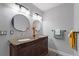 Beautiful bathroom with granite countertop, double sinks, and decorative mirrors at 222 Via Mariel E Dr, Davenport, FL 33896