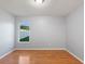 This bedroom features laminate wood flooring, neutral walls, and a single window at 222 Via Mariel E Dr, Davenport, FL 33896