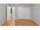 Bright bedroom with wood laminate flooring, closet with sliding doors, and an open doorway at 222 Via Mariel E Dr, Davenport, FL 33896