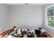 Light-filled bedroom with laminate flooring and a large window overlooking the lush green yard at 222 Via Mariel E Dr, Davenport, FL 33896